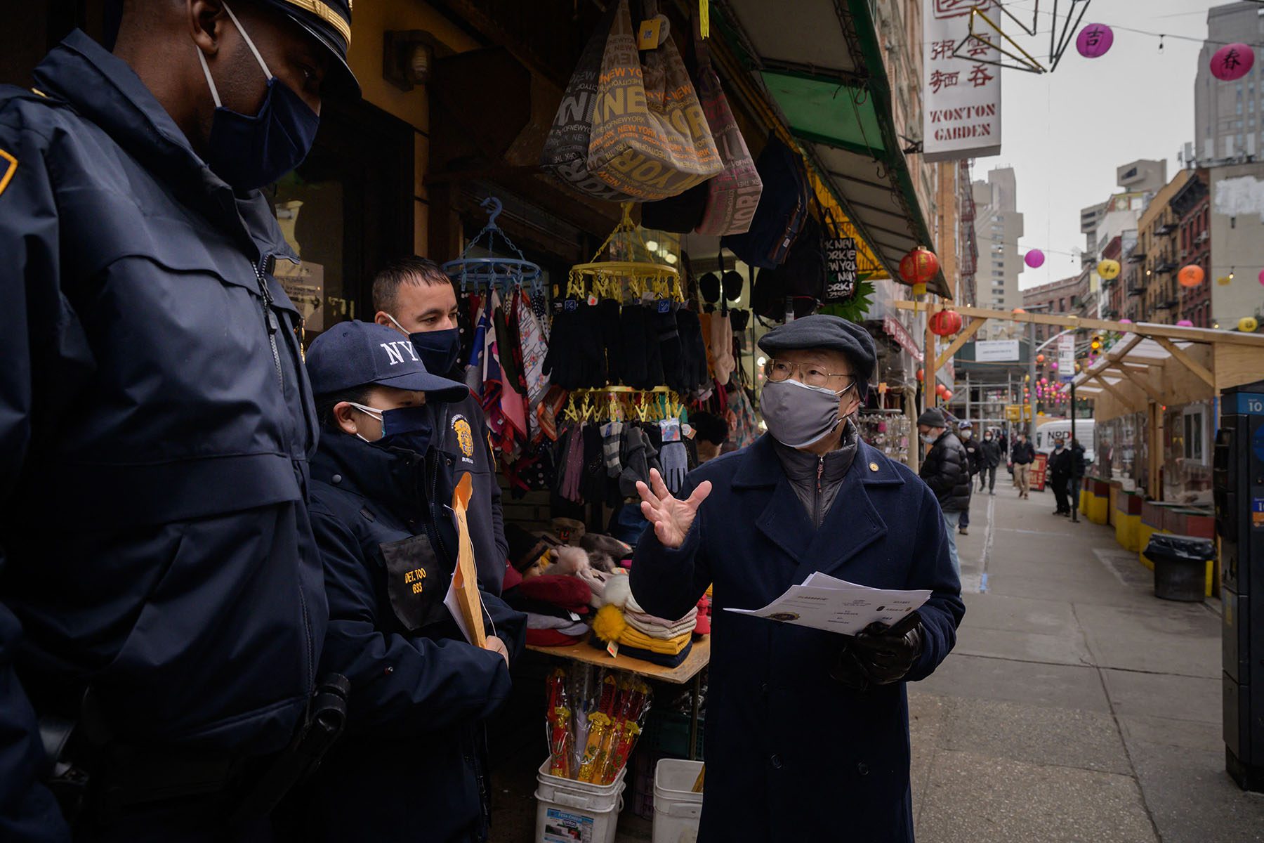 A resident speaks to police officers handing out information advising how to report hate crimes.