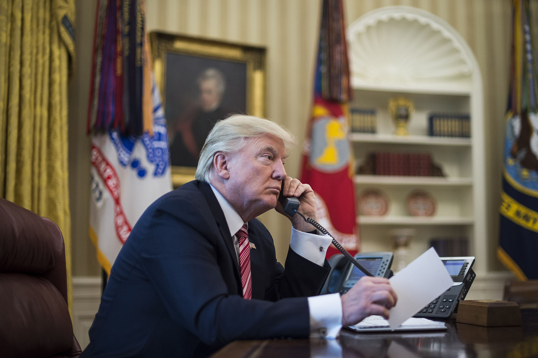 President Trump speaks on the phone in the oval office of the White House.
