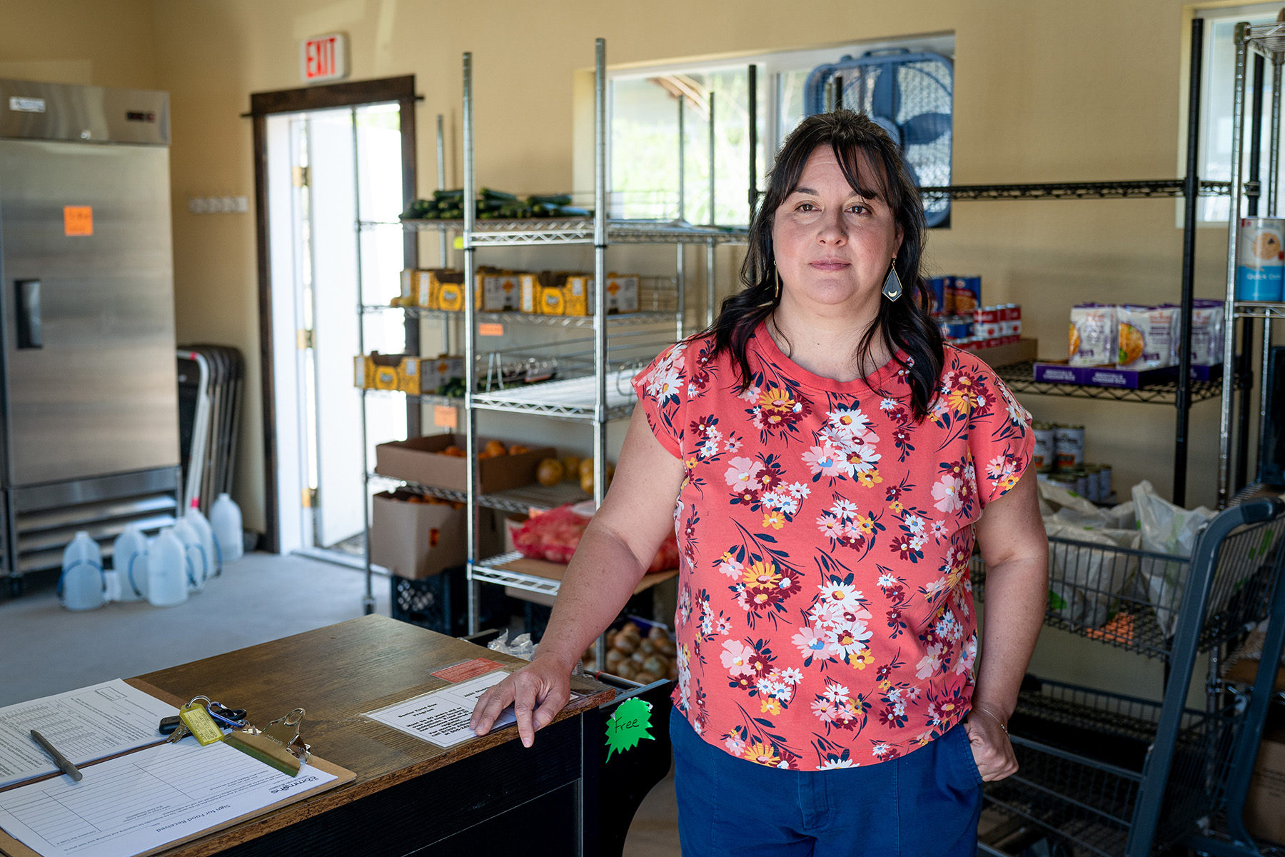 A woman stands in a kitchen.