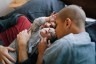 Two parents hold their child.